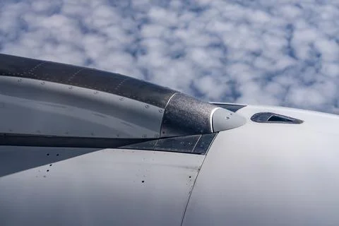 View through airplane window during flight on a Sunny day with cloudy sky Stock Photos