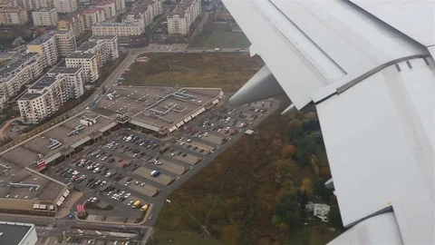 View through an airplane window. Flying over the city through clouds Stock-Footage 72193947