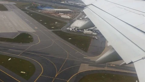 View through an airplane window. Flying over the city through clouds Vidéo 72194065