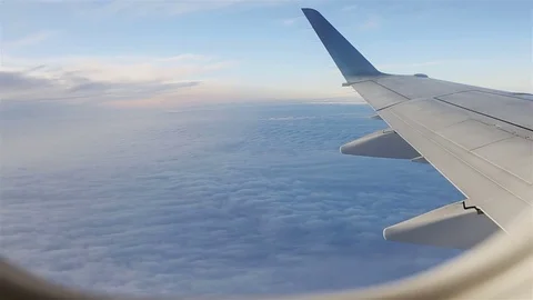 View through an airplane window. Flying through cirrus and cumulus clouds Video stock 80521718