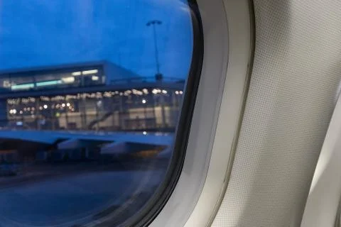 View through the airplane window to the passenger terminal of schiphol airpor Stock Photos
