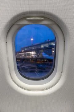 View through the airplane window to the passenger terminal of schiphol airpor Stock Photos