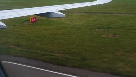 View through an Airplane window. Plane taking off from airport runaway 스톡 동영상 112818838