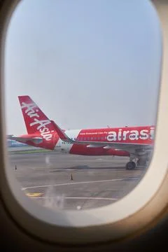 View through an airplane window showing another aircraft on the airport run.. Stock Photos