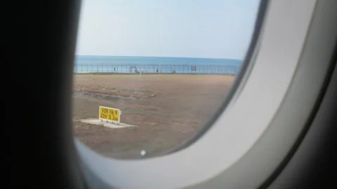View through airplane window while taxi with view of sea ocean under clear .. Stock Footage 243992333