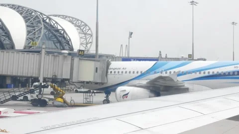 View through airplane window while aircraft arriving to airport terminal at.. Stock Footage 277354233