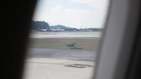 View through airplane window while taxi ready for take off travel at the ai.. Stock Footage 324705617