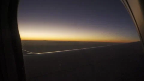 View through airplane window while flying over sunset sky landscape with tw.. Stock Footage 338331311