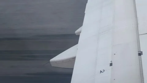 View through airplane window to the wing while aircraft running for take of.. Stock Footage 248028927