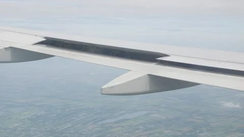View through airplane window with wing view while spoiler air break was dep.. Stock Footage 296089772