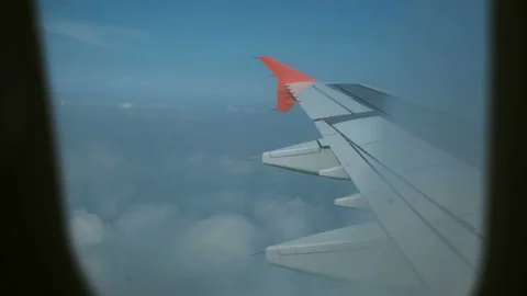 View through the airplane's window, wing, clouds, blue sky nature 스톡 동영상 94030645
