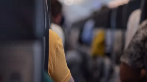 View through aisle between seats in airplane passenger cabin Stock Footage 301382658