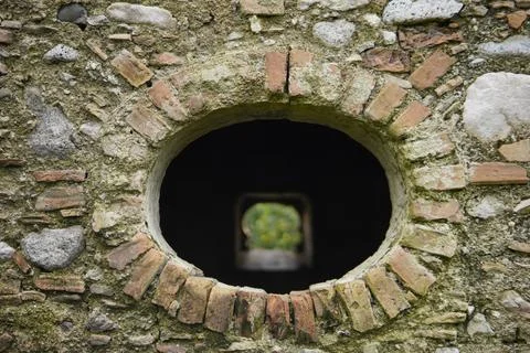View Through Ancient Circular Stone Window. Stock-Fotos