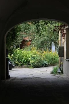 View through the arch to the old courtyard. Authentic image. Stock Photos