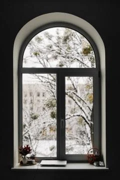View through arch window on snowy scene. Christmas at home Stock Photos
