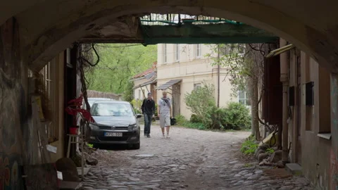 View Through an Archway into a Cobbled Courtyard in Vilnius Old Town Stock Footage 334771445