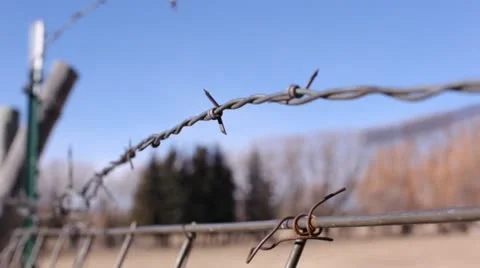 View Through Barbed Wire fence at Natural Mountain Background Stock Footage 21257936