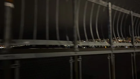 View through bars off big metal bridge at night in Tromso, Norway Stock Footage 301554866