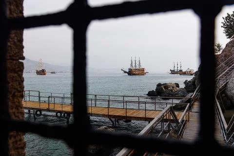 View through the bars of old pirate ships Stock Photos