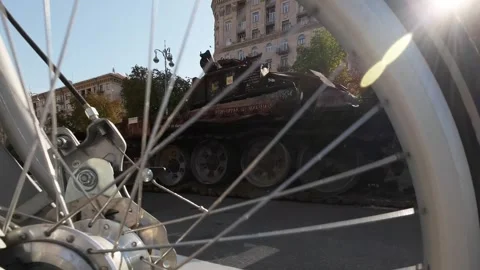 A view through a bicycle wheel at the destroyed Russian military equipment .. Stock Footage 248602020