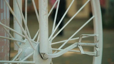 View through bicycle wheel on walking people on the urban street. Part of white 動画素材 100036870