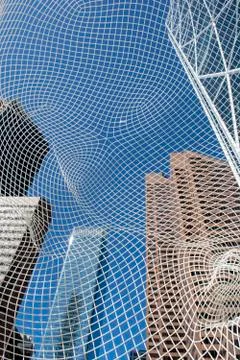 View through big mesh head public art display in front of office tower Stock Photos