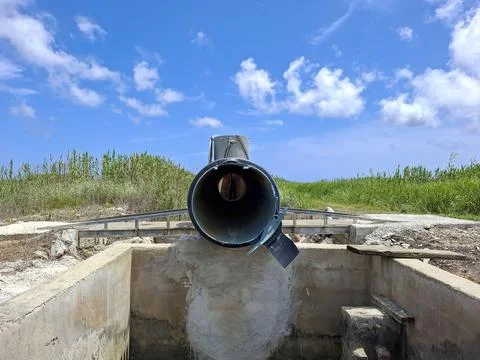 View through a black irrigation pipe in rural rice fields of Pego Spain Stock Photos