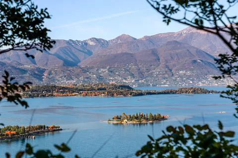 View through the branches of the trees to the little Rabbit island on the Lak Stock Photos