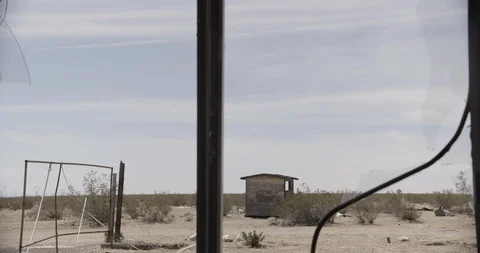 View through Broken Window at Desert Shack Stock Footage 89942010
