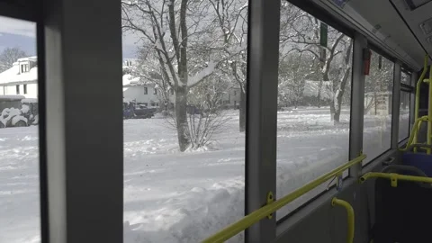 View through bus window in Munich, Germany of snowy streets, snow covered city Stock Footage 318980385