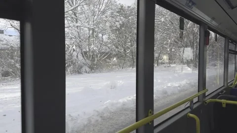 View through bus window in snowy Munich, Germany, reveals streets blanketed in Video stock 318978031