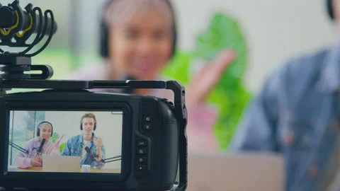 View Through Camera Of Couple Wearing Headphones Vlogging Live Streaming Video stock 220611168