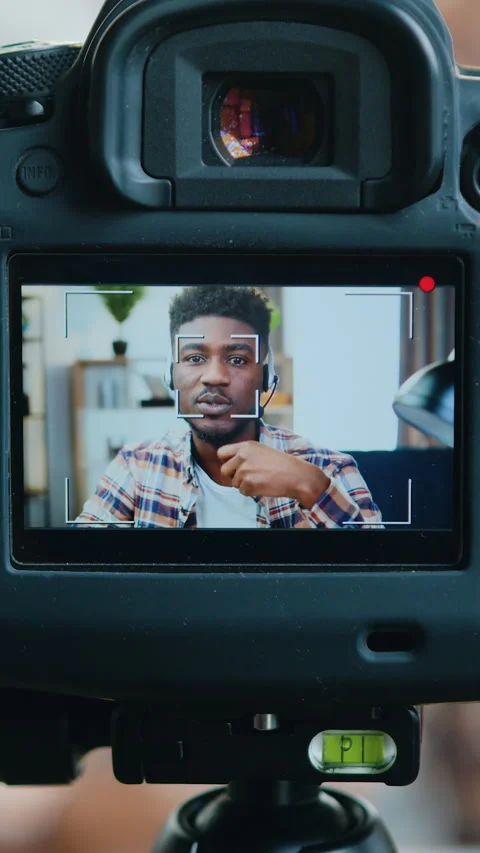 View through camera lens of good-looking modern successful black-skinned male bl Stock Footage 325314614