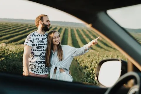 View through car window, happy middle-aged couple hugging together in the 스톡 사진