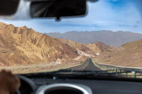 View through a car windshield on iran sharp rocky mountains on a road Stock Photos
