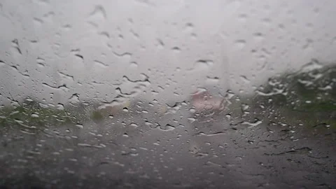 A view through the car windshield of a pouring rain on the highway  Stock Footage 276820857