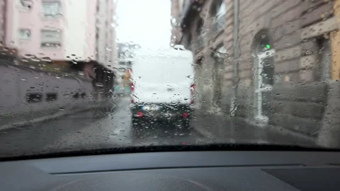 View through car windshield with rain drops on fall day in Paris with white van Stock Footage 142576134