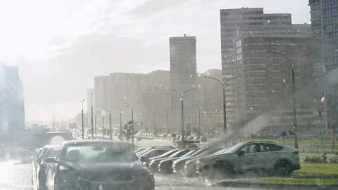 View through car windshield shows heavy rain falling on city windshield wipers Stock Footage 280120138