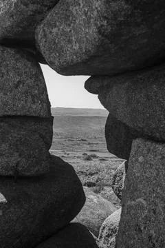 View through Cheesewring Rock formation on Bodmin Moor framed by granite Stock Photos