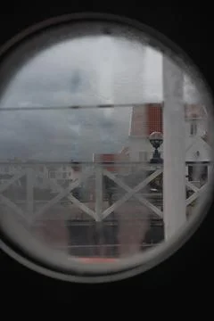 View Through Circular Window of Coastal Houses in Norway Stock Photos