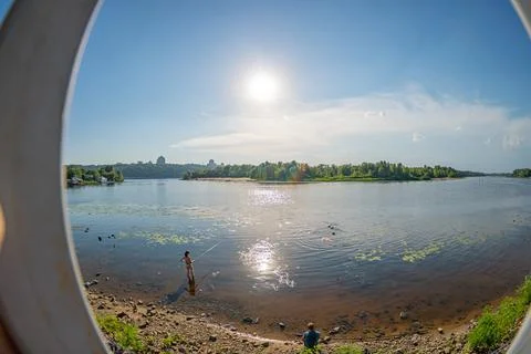 View through a circular window of a serene waterfront scene, possibly from a  Stock Photos
