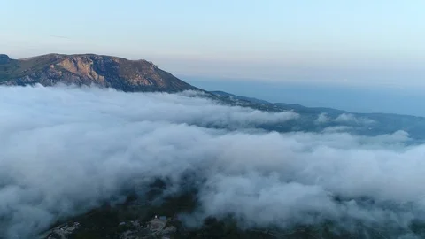 View Through the Clouds of the Settlement and the Road. Mountains above the Clou Stock Footage 126267600