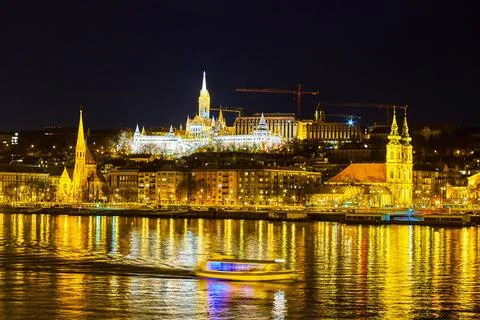 The view through Danube river on bright Fisherman's Bastion on the hill, Bu.. Photos
