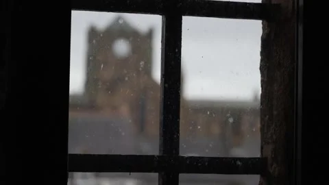 View Through a Dirty Window With a Blurred Silhouette of an Old English Church Stock Footage 260335676