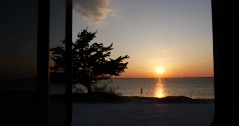 View through a door or window of a colorful tropical marine sunset Stock Footage 150198436