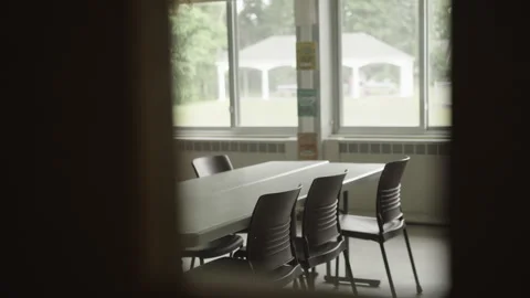 View Through Door Window into Empty Middle or High School Classroom with Tables Stock Footage 308460223