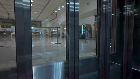 View Through Elevator Doors Into Lanzarote Airport Terminal With Walking Stock Footage 337017064