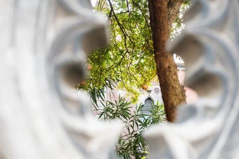 View through the fence pattern of the old building architecture. Stock Photos