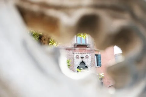 View through the fence pattern of the old building architecture. Stock Photos