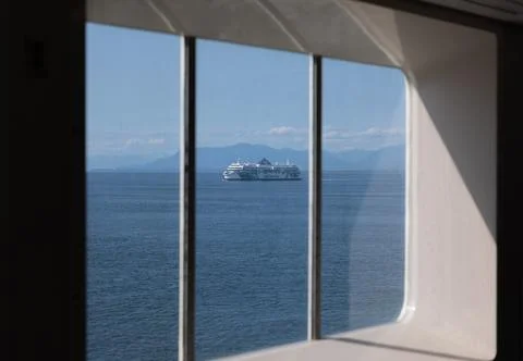 The view through ferry ship window across a sea to another ferry going to V.. Stock Photos